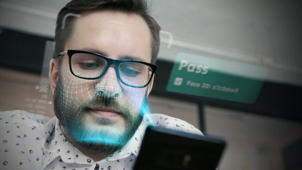 Person looking at phone and camera scanning face