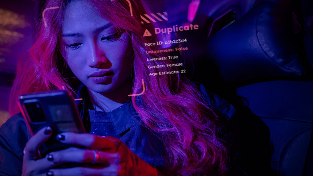 Young woman looking at phone trying to sign in with a duplicate account