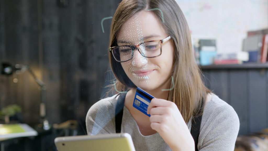 Young woman signing in to her bank using her face