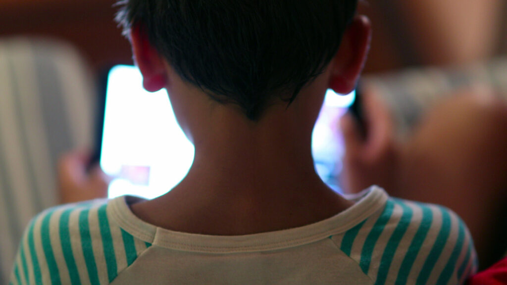 Young boy looking at device