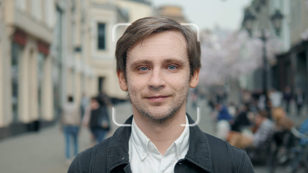Man standing in a street looking directly to camera