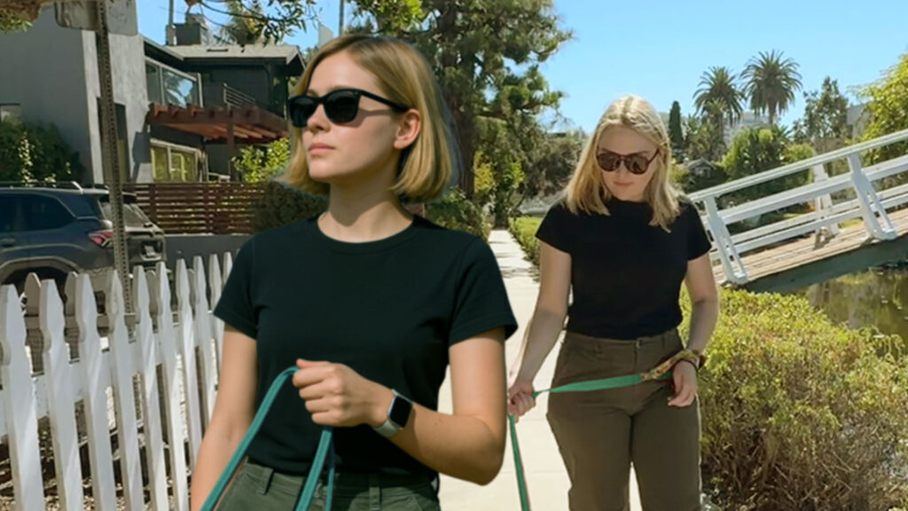 Two young women wearing the same clothing, walking their dogs